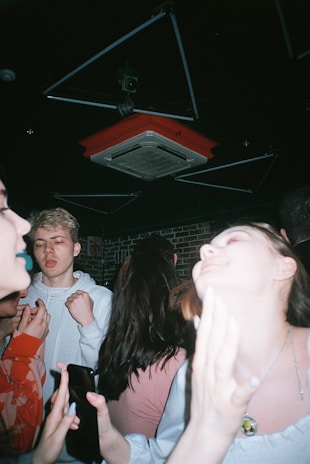woman in white long sleeve shirt standing beside man in red shirt