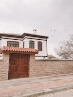 brown wooden door on white concrete building