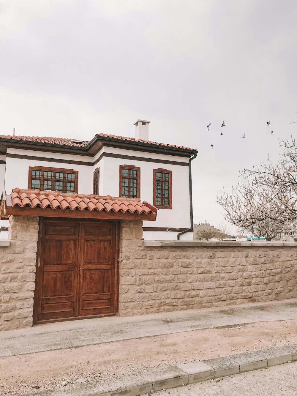 brown wooden door on white concrete building