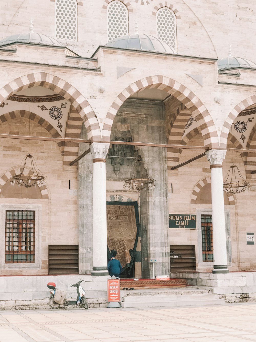 people sitting on bench in front of building