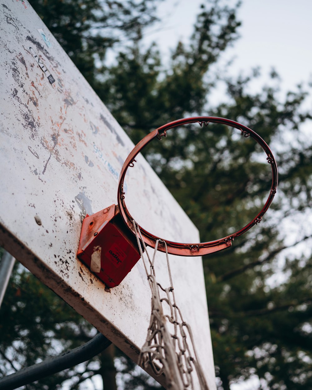 red basketball hoop on white concrete wall