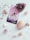 A tarot card titled '3 of Cups' is surrounded by various gemstones and crystals including amethyst, quartz, and rose quartz. The card features three women in white dresses embracing each other against a starry sky. Lavender sprigs are scattered around for decoration.