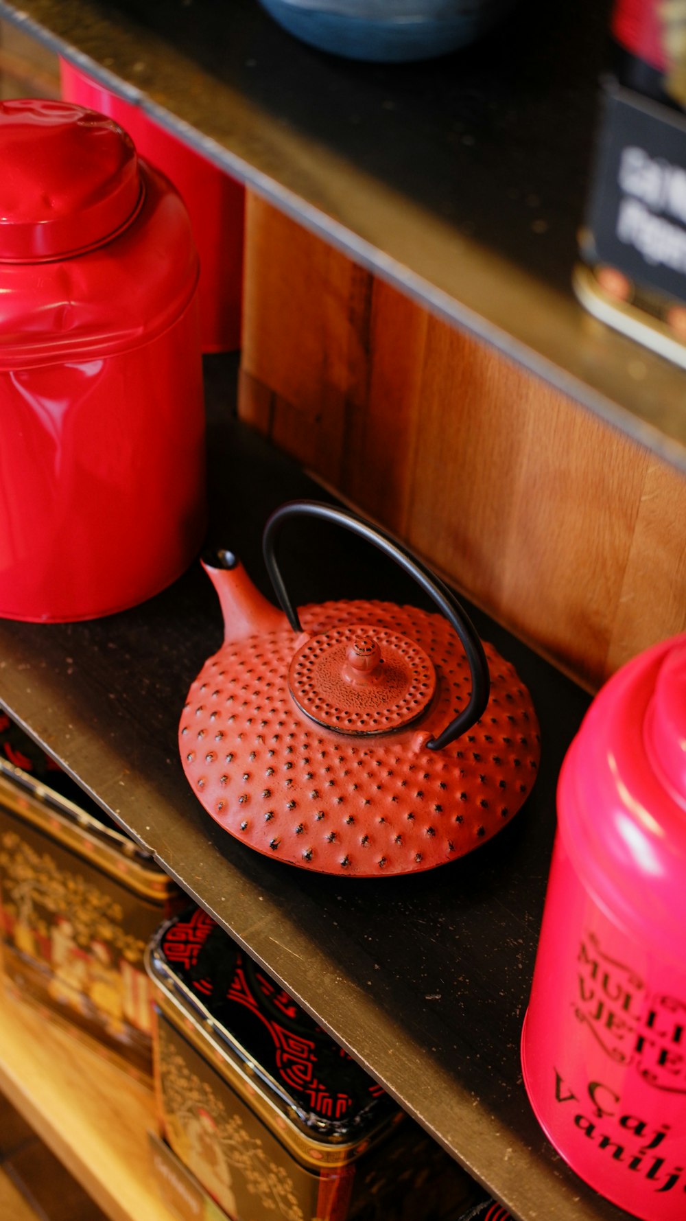 red plastic pitcher on brown wooden table