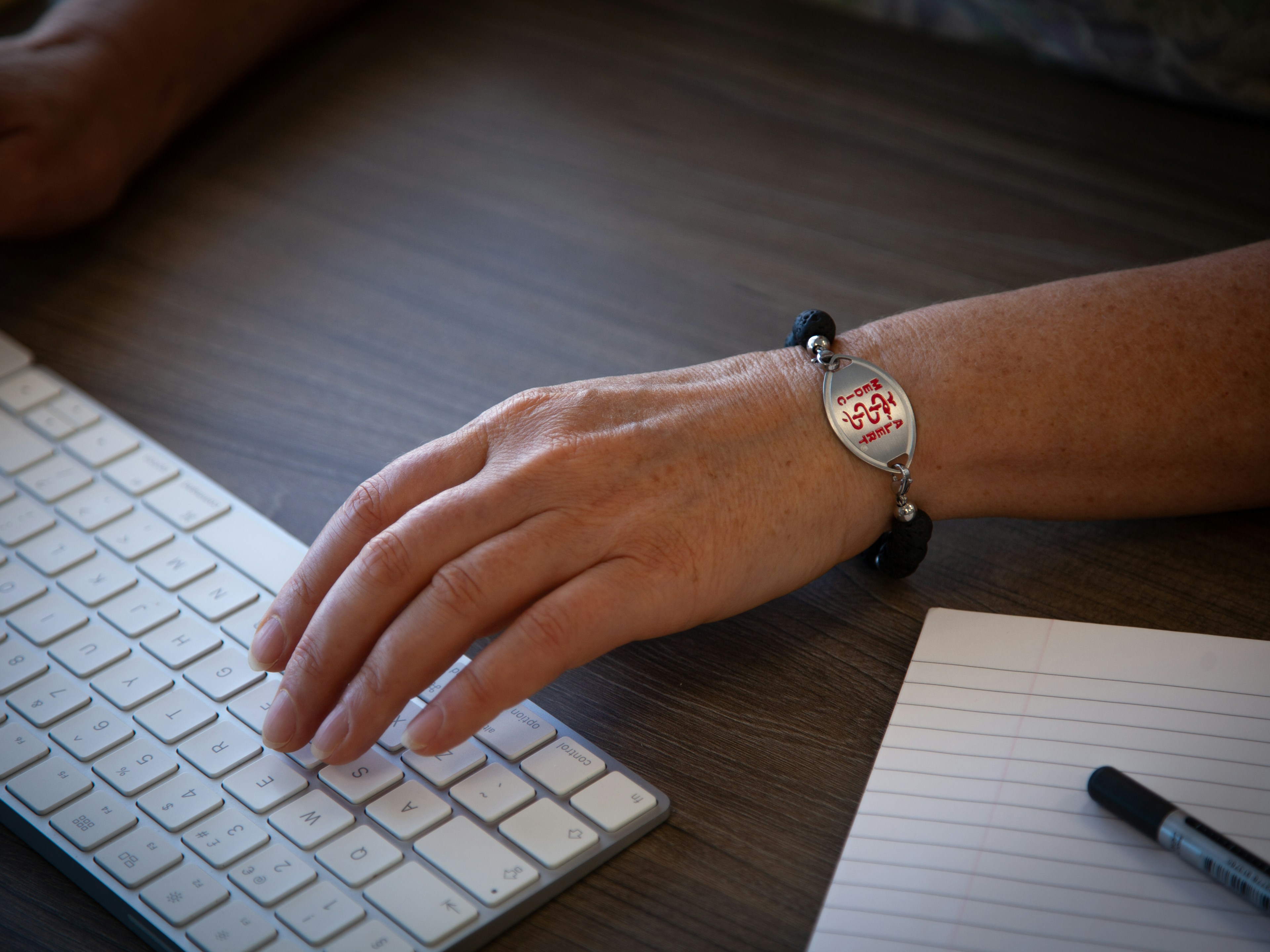 person wearing silver round analog watch