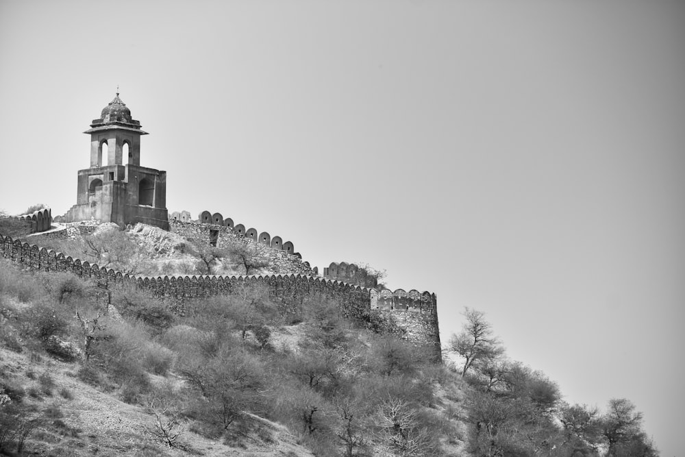 grayscale photo of castle on hill