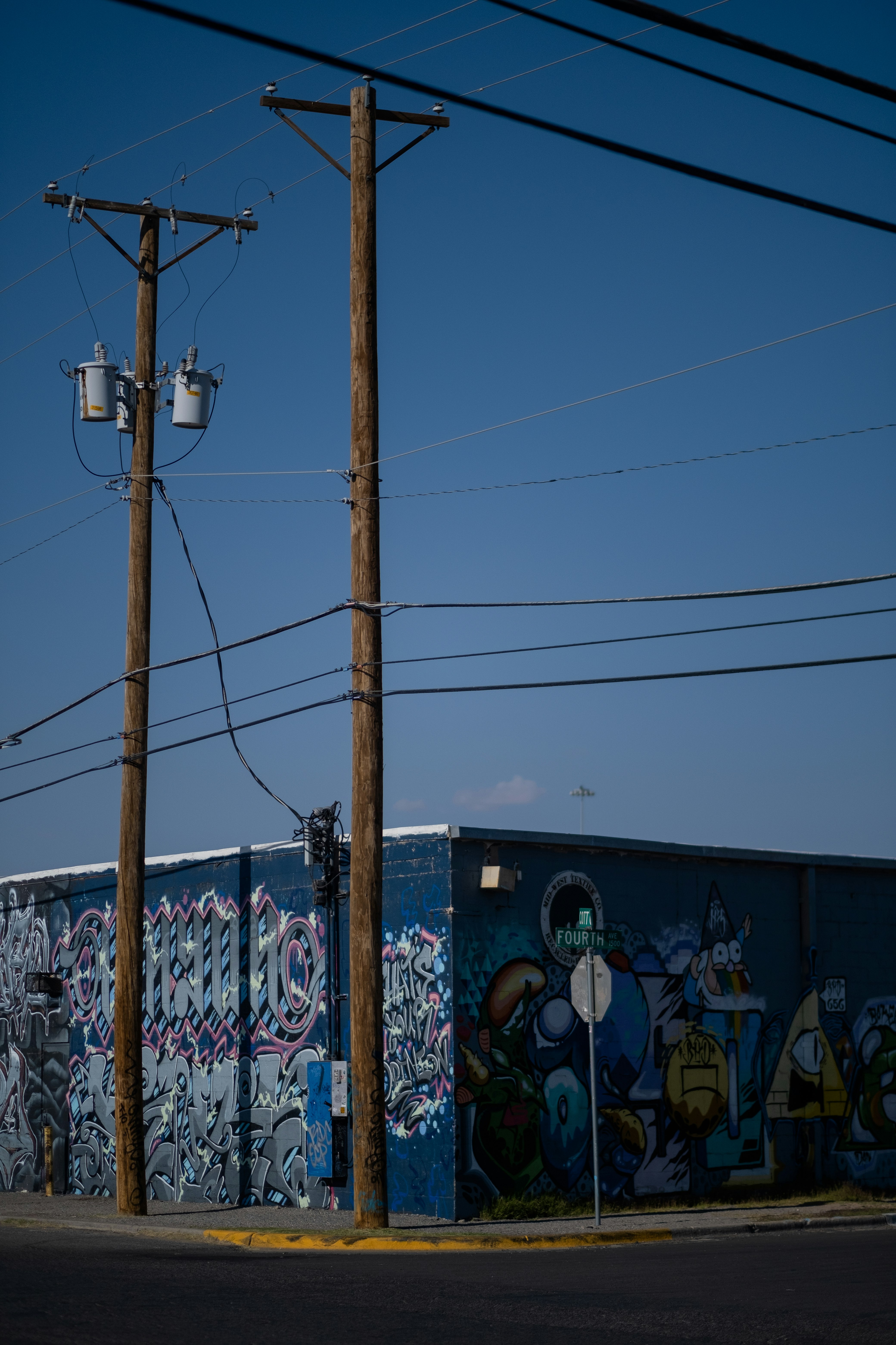 brown electric post with graffiti