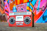 A vintage boombox surrounded by colorful neon lights.