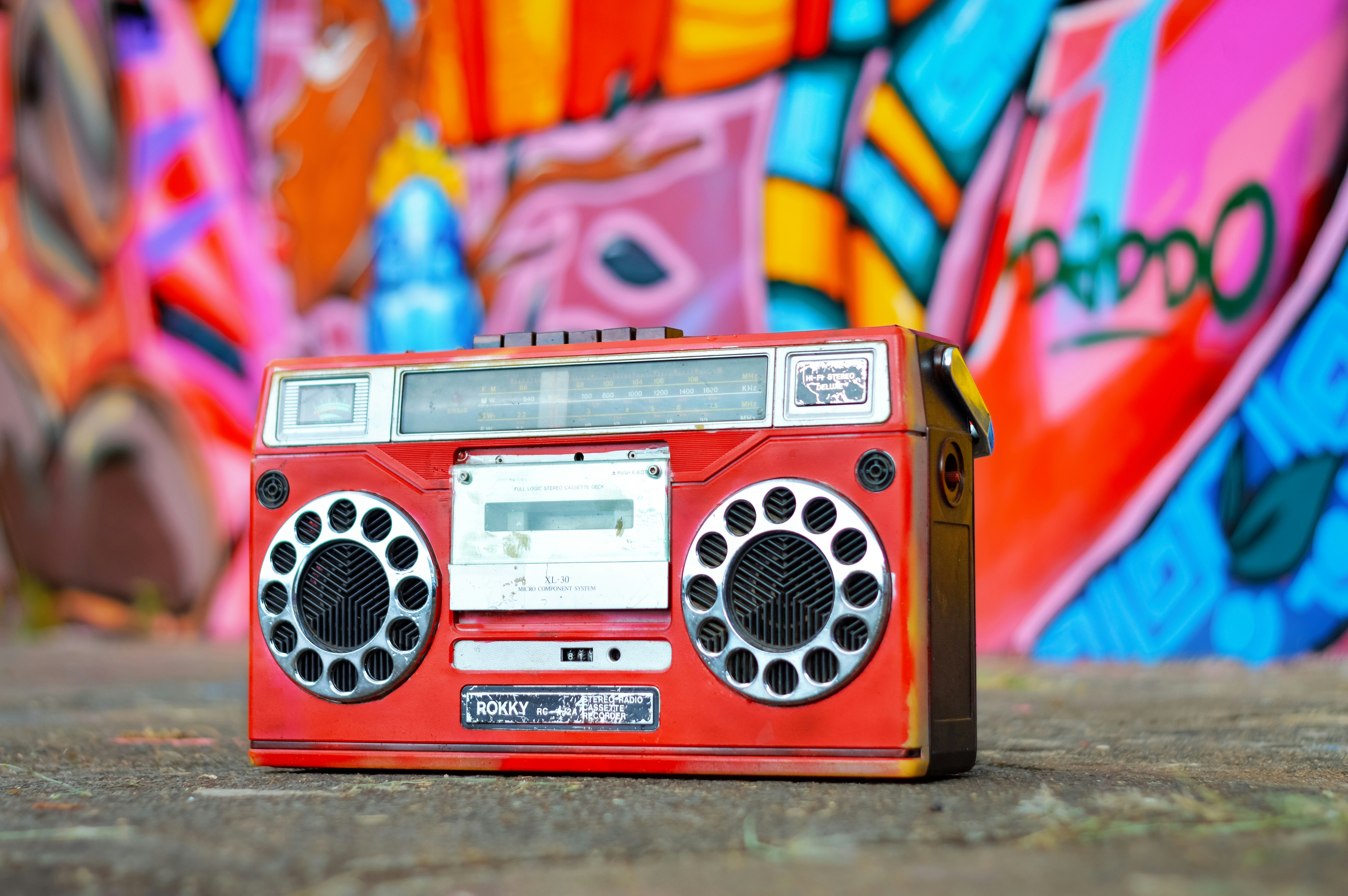 red and silver radio on pink and yellow textile