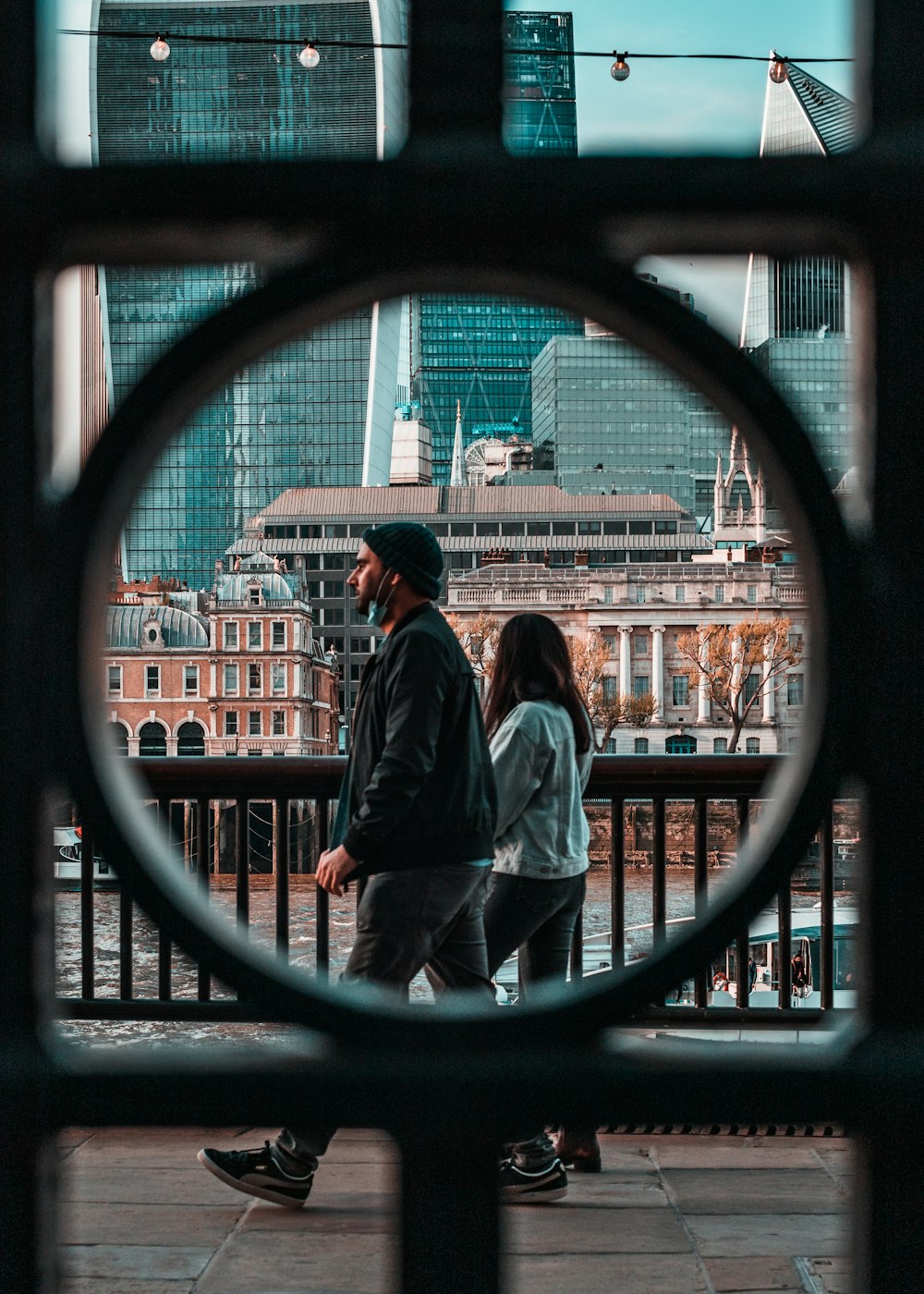 hombre y mujer de pie frente a una ventana de vidrio