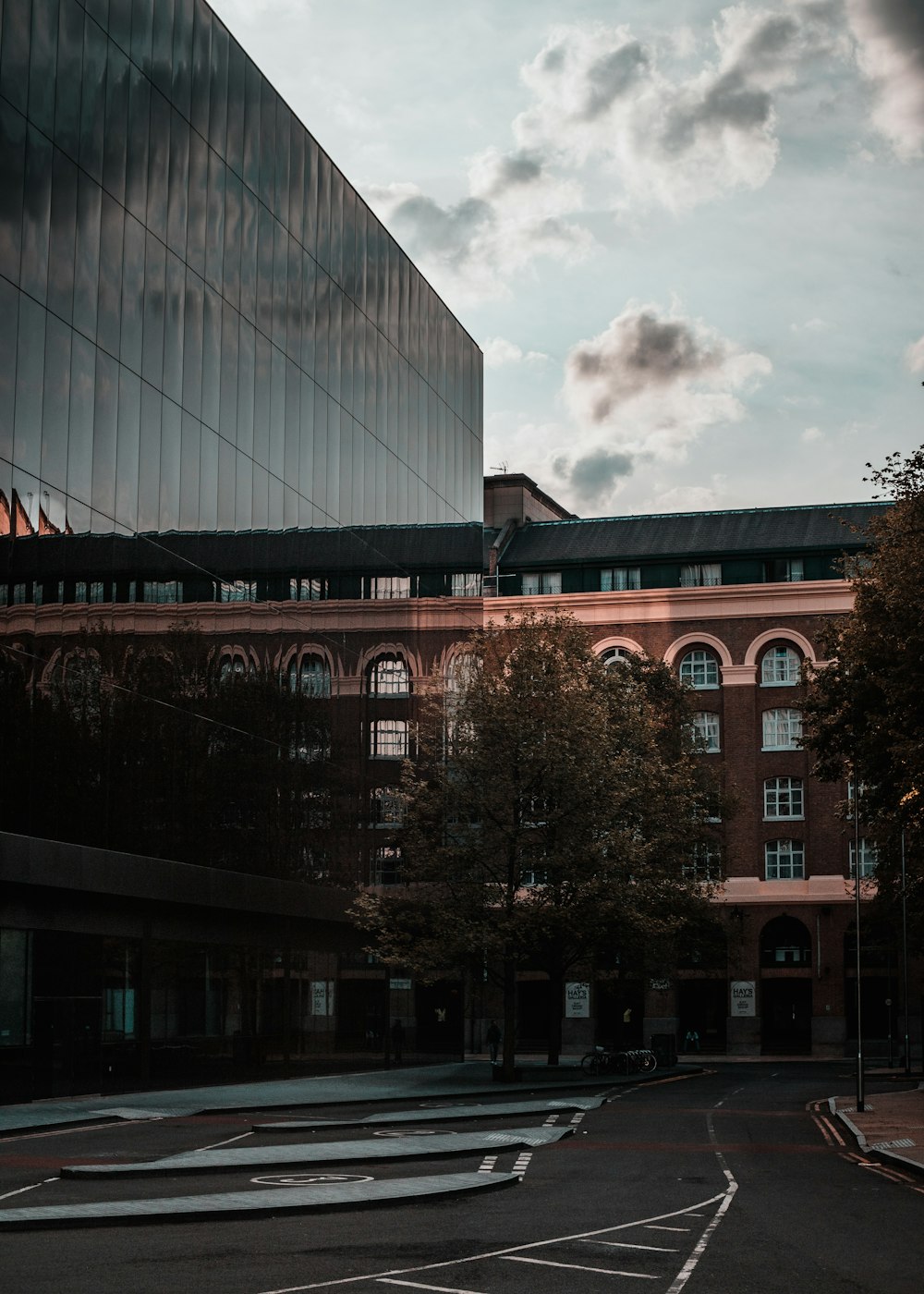 brown concrete building under white clouds during daytime