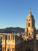 white concrete building near mountain during daytime