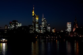 A picturesque city skyline illuminated at night.