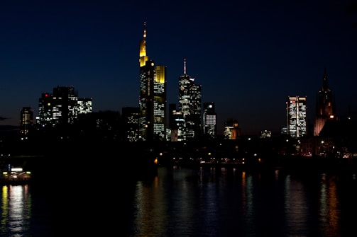 A picturesque city skyline illuminated at night.