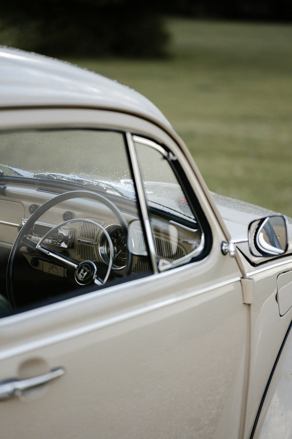 white vintage car on green grass field during daytime