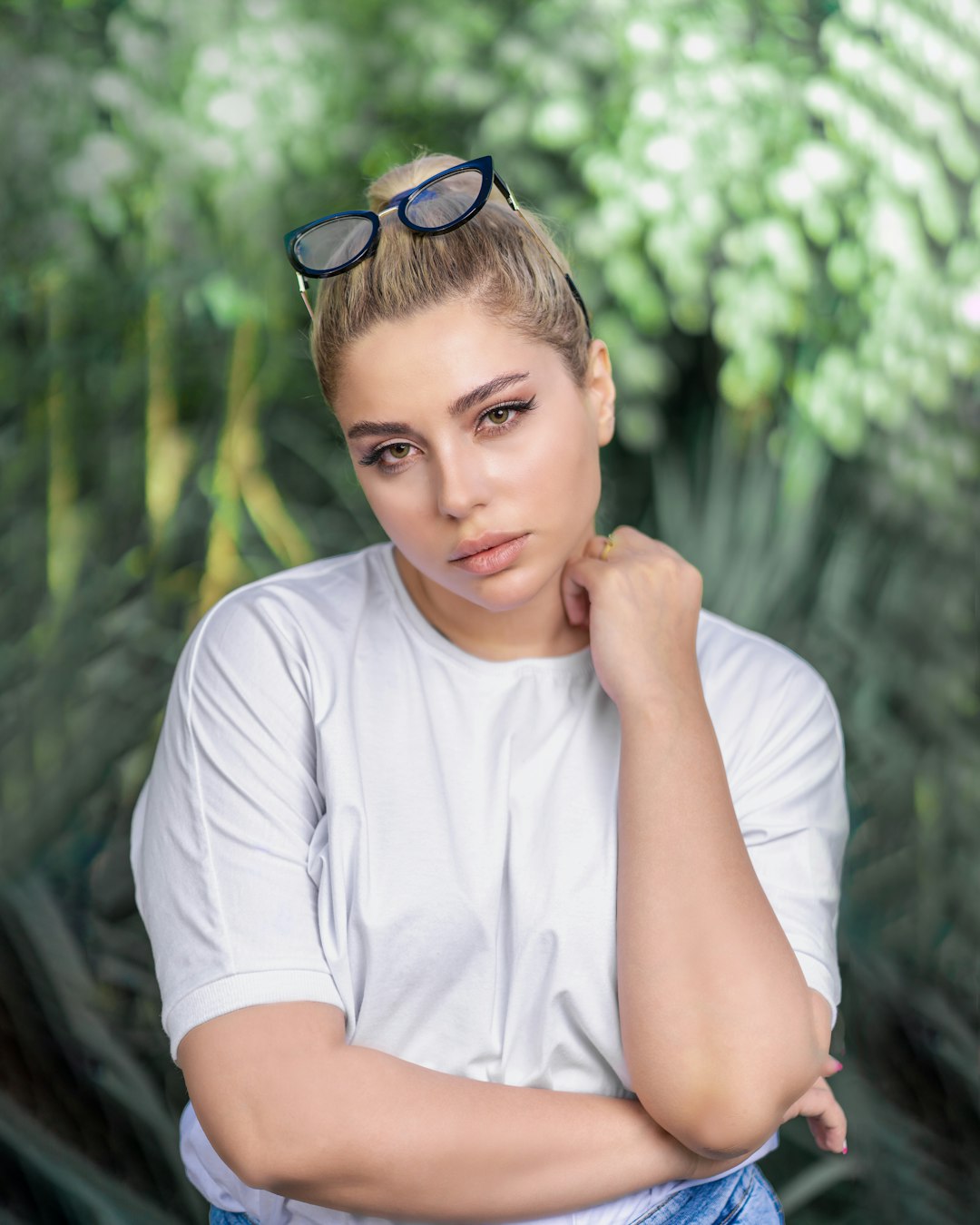 woman in white crew neck t-shirt wearing blue sunglasses