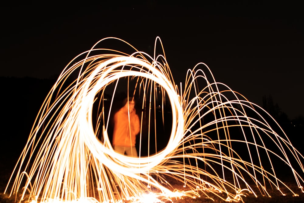 man in black shirt with light in time lapse photography