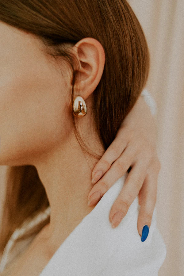 Diamond stud earring being worn