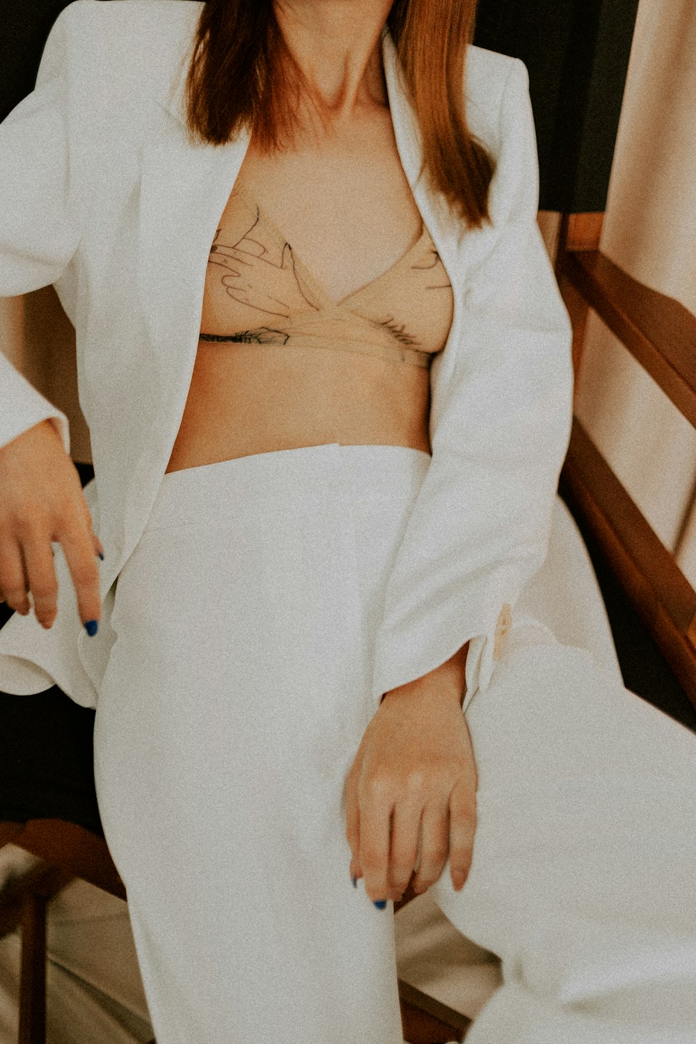 woman in white robe sitting on bed