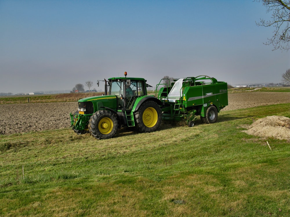 green tractor on green grass field under white sky during daytime