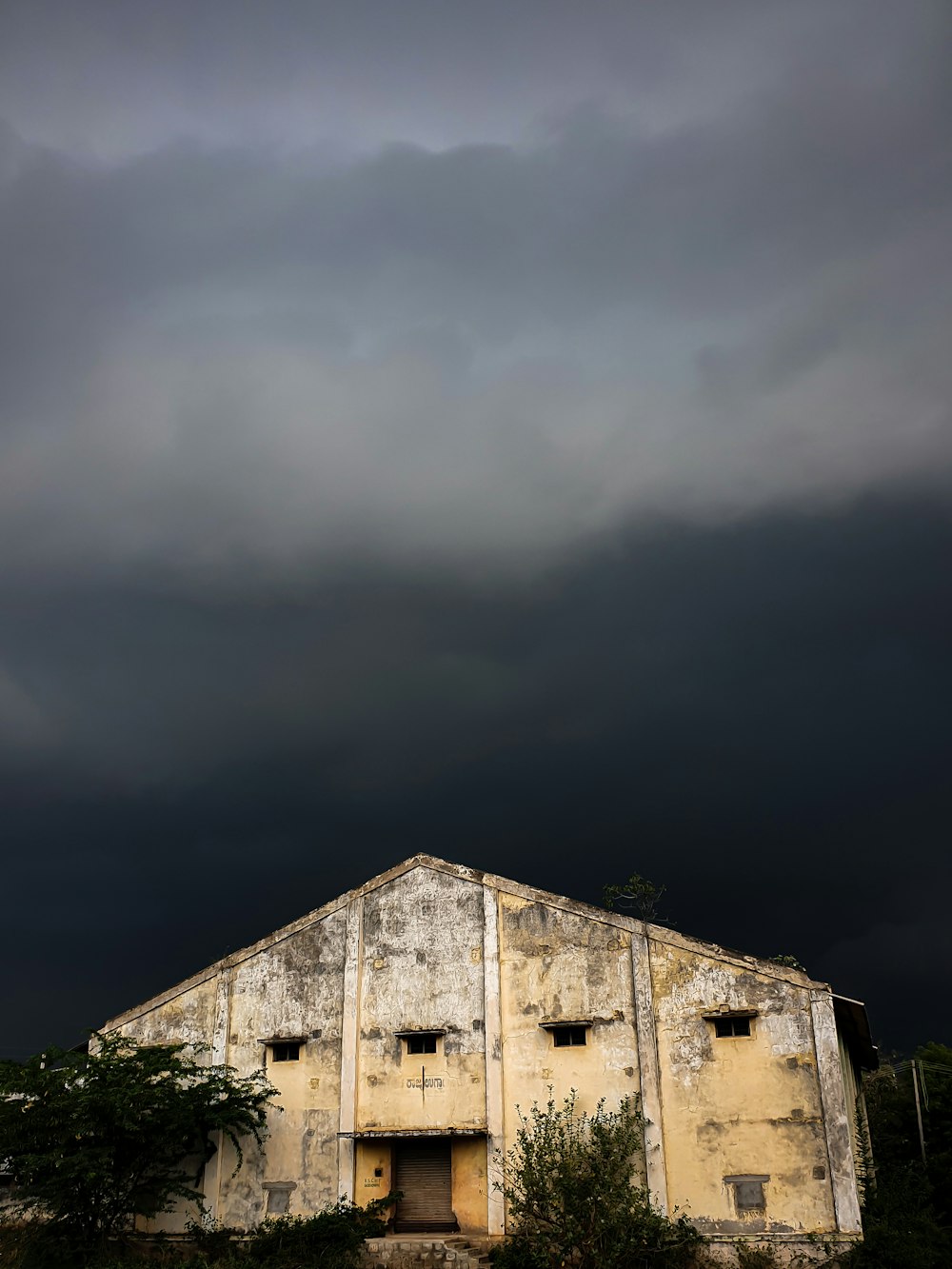 white wooden house under gray sky