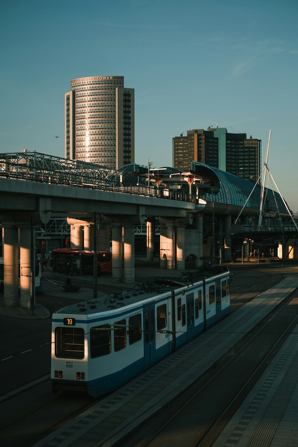 white and blue train on bridge during night time