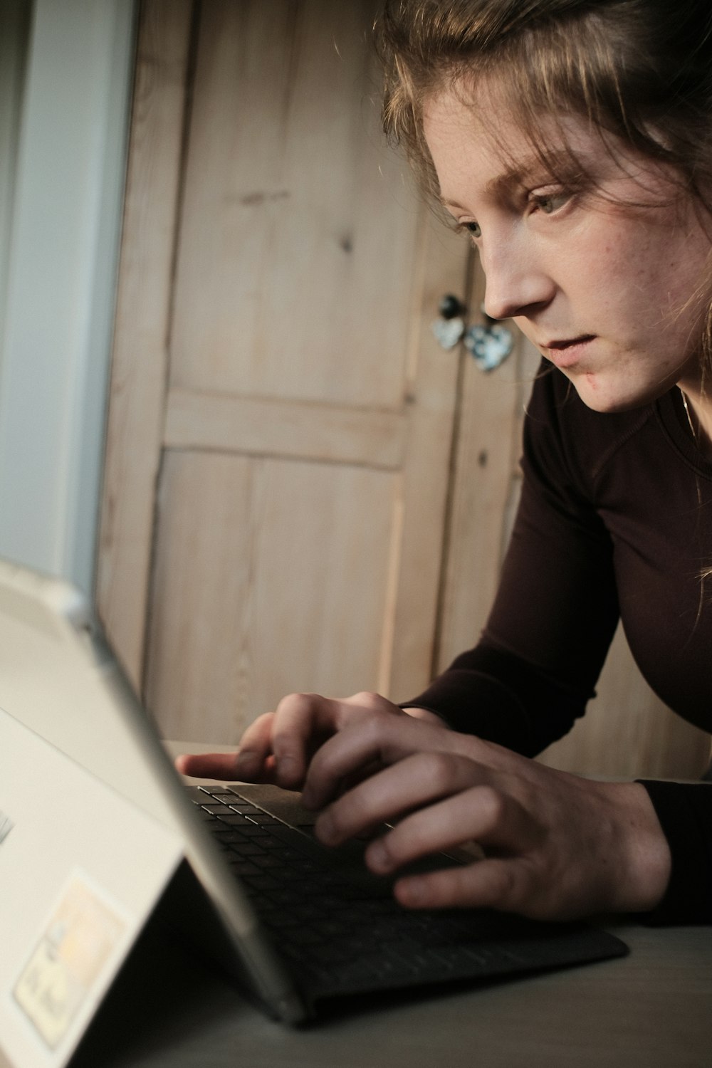 man in brown long sleeve shirt using macbook pro