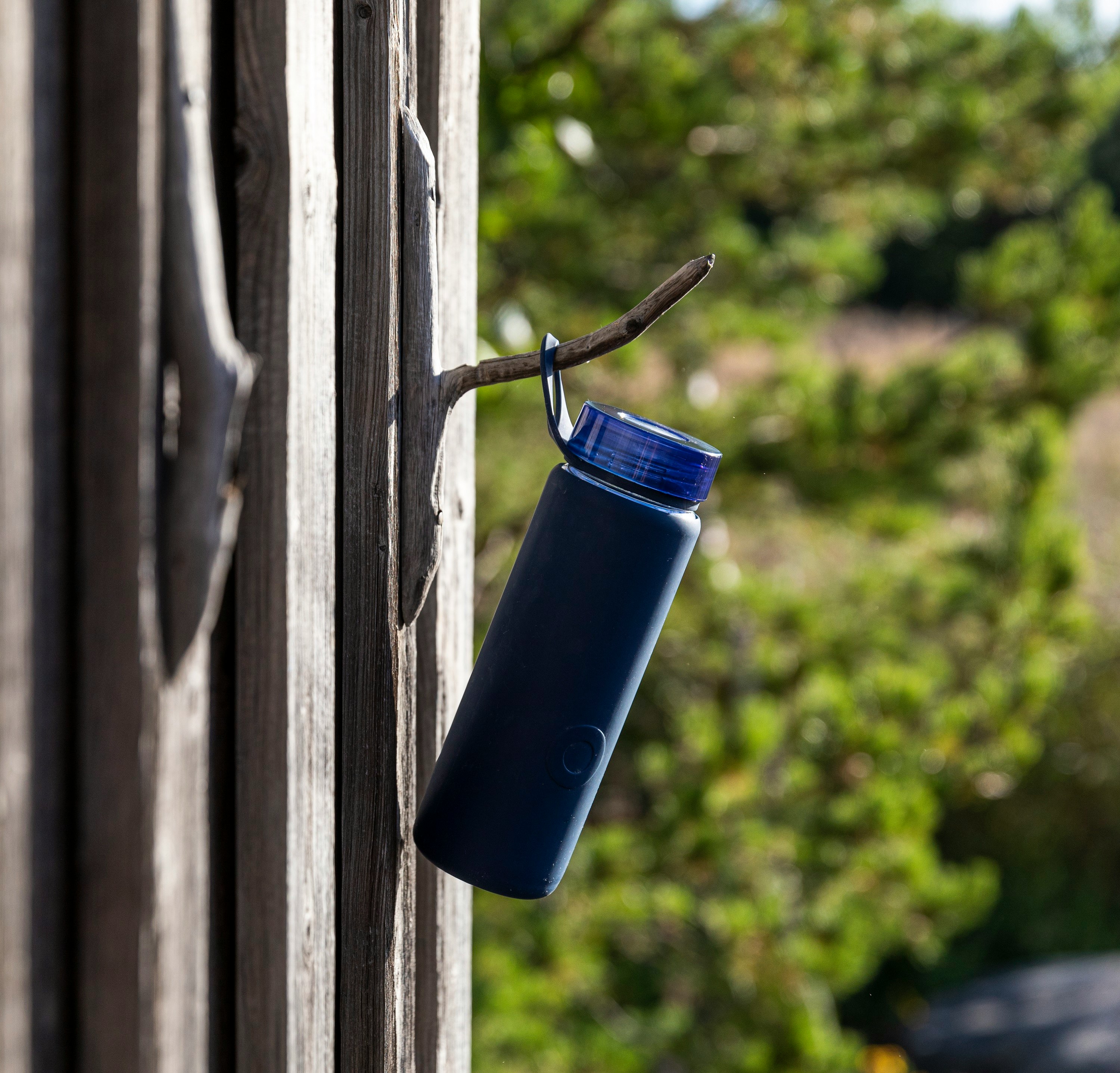 blue plastic cup on gray wooden window
