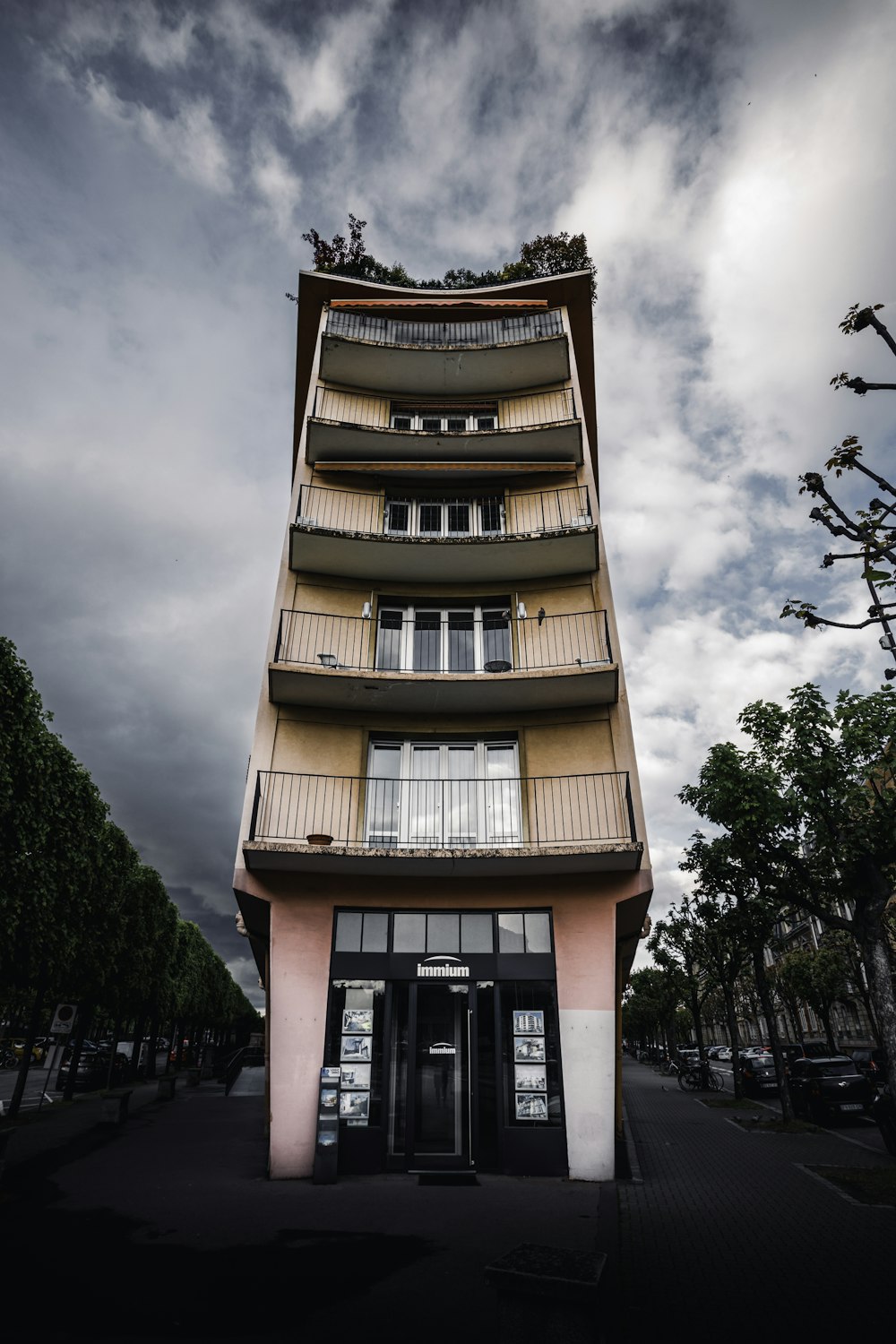 white and brown concrete building under cloudy sky during daytime