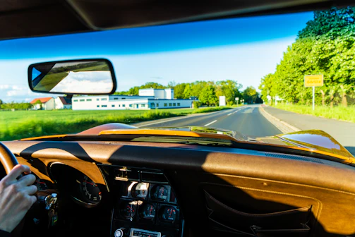A professional driver behind the wheel of a family car on a clear road