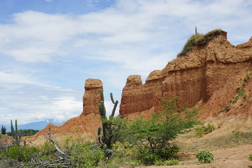 brown rock formation under white clouds during daytime