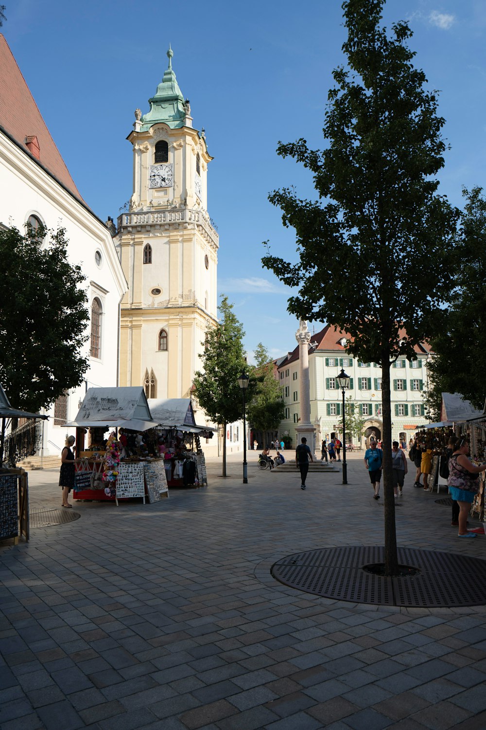 people walking on street near white concrete building during daytime