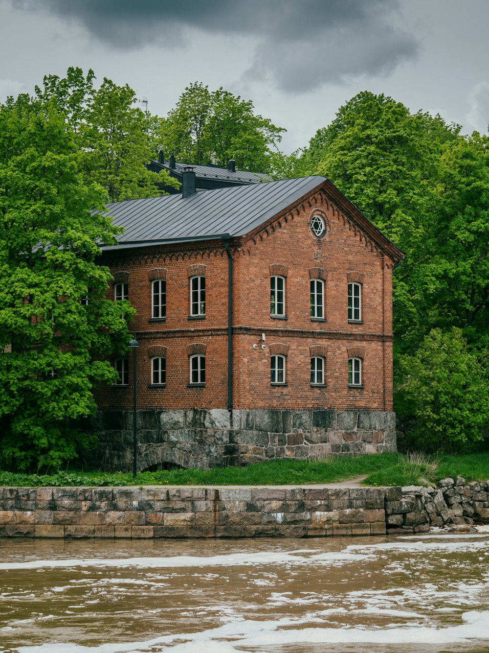 brown concrete building near green trees during daytime