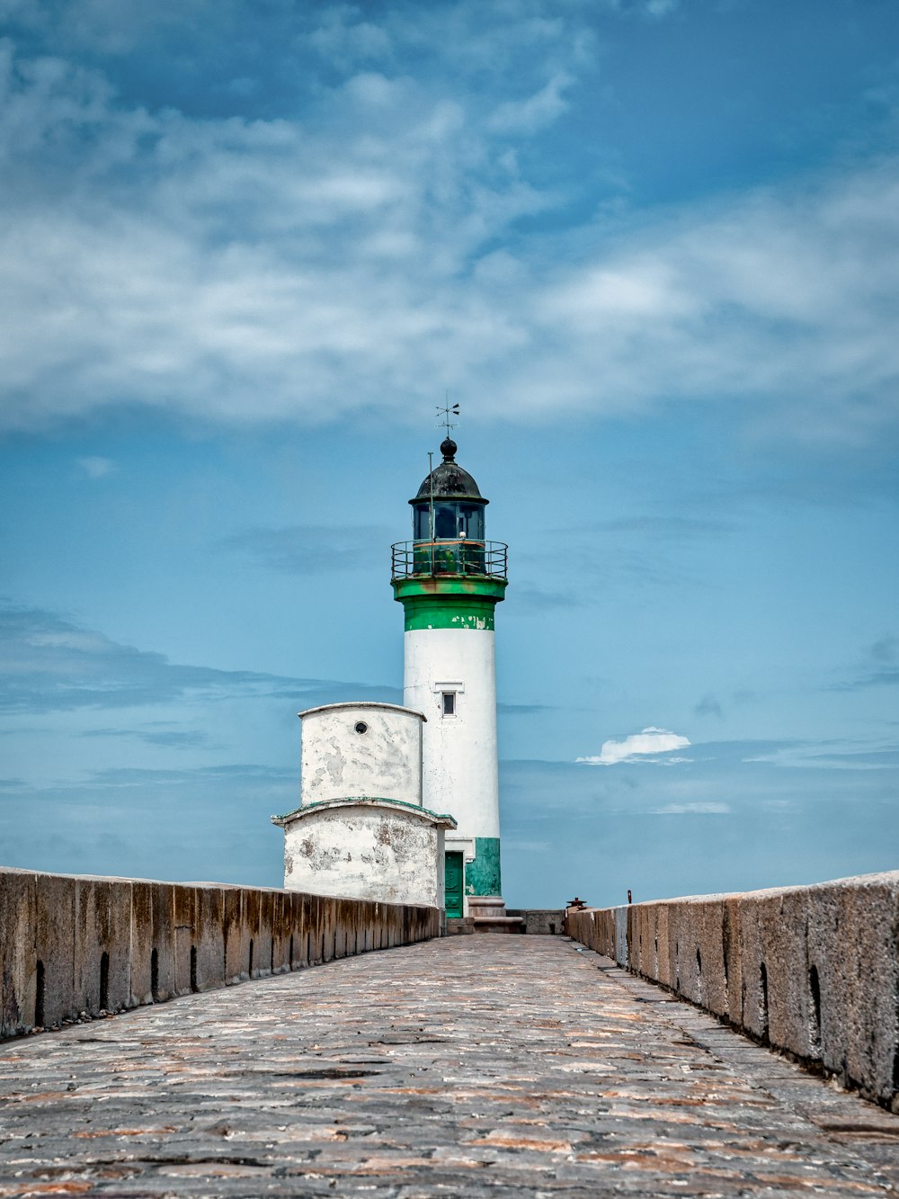white and green lighthouse under blue sky