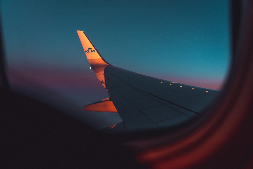 airplane wing under blue sky during daytime