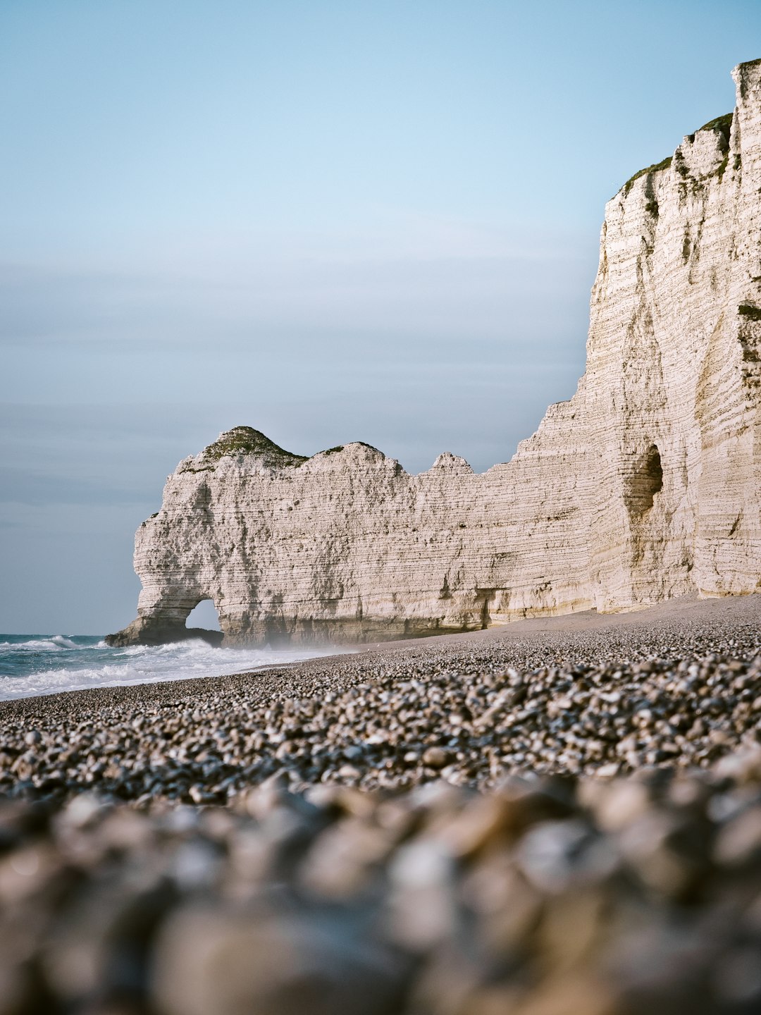 brown rock formation near body of water during daytime