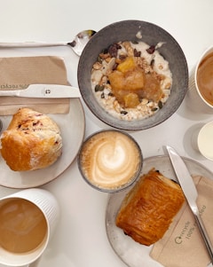 bread on white ceramic plate beside bread on white table