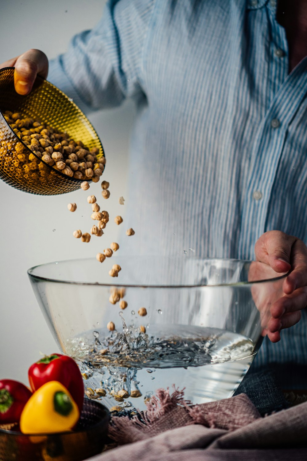 person holding clear glass bowl with corn