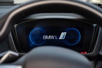 Close-up of a BMW dashboard displaying Apple CarPlay interface.