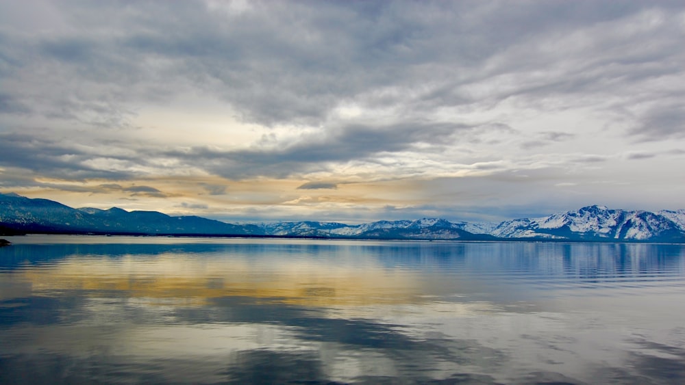 body of water under cloudy sky during daytime