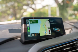 Fleet management team reviewing route optimisation maps on digital screens to reduce carbon footprint.