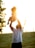 A joyful parent holding their toddler in a park.