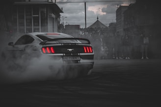 white and black porsche 911 on road during daytime