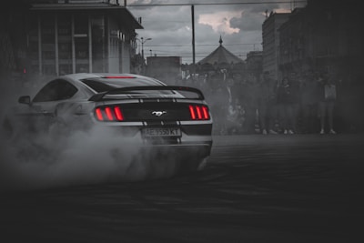 white and black porsche 911 on road during daytime