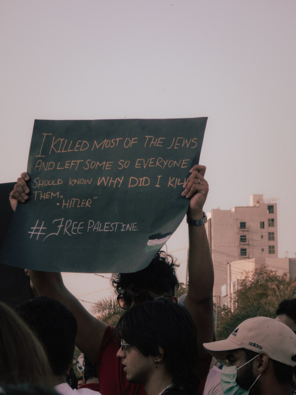 person holding blue and white quote board