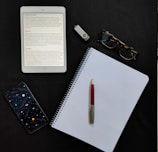 black iphone 7 beside white paper and black iphone 5