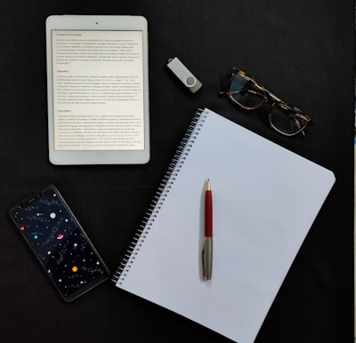 black iphone 7 beside white paper and black iphone 5