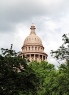 brown concrete dome building under white clouds during daytime