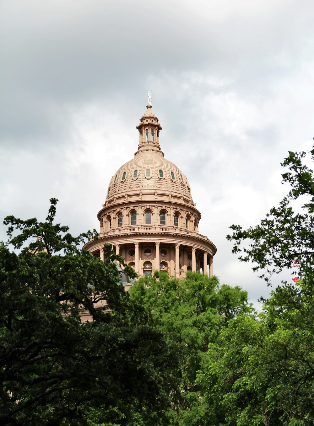 brown concrete dome building under white clouds during daytime