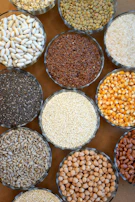 Pulses like toor dal and chana dal displayed in rustic bowls.