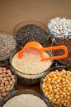 brown and white beans in clear glass bowls